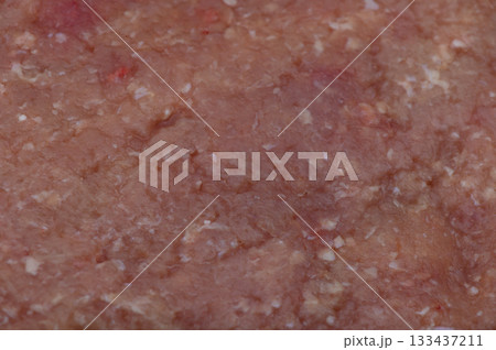 Richly textured ground meat displayed on a cutting board in a cozy kitchen setting during afternoon preparation Richly textured ground meat displayed on a cutting board in a cozy kitchen setting during afternoon preparation 133437211