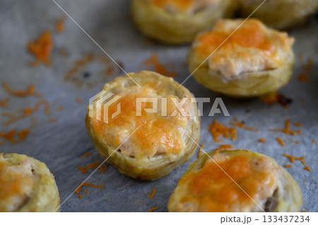 Mouthwatering savory pastries filled with cheese and herbs baked to perfection at an afternoon gathering Mouthwatering savory pastries filled with cheese and herbs baked to perfection at an afternoon gathering 133437234