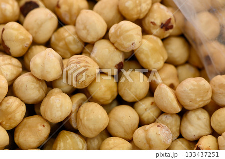 Crunchy hazelnuts collected during the harvest season in a sunlit grove showcasing nature's bounty Crunchy hazelnuts collected during the harvest season in a sunlit grove showcasing nature's bounty 133437251