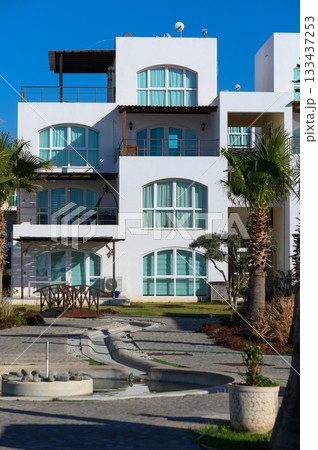 Stunning beachfront architecture showcases unique design and vibrant landscaping in a tropical paradise Stunning beachfront architecture showcases unique design and vibrant landscaping in a tropical paradise 133437253