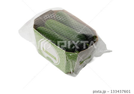 Fresh mini cucumbers in cardboard packaging on white 133437601
