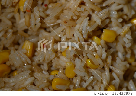 Delicious corn and rice blend prepared with spices in a cozy kitchen setting during a sunny afternoon Delicious corn and rice blend prepared with spices in a cozy kitchen setting during a sunny afternoon 133437978