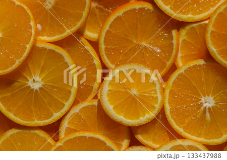 Freshly sliced oranges create a vibrant and zesty display, perfect for summer refreshment and culinary delights 133437988