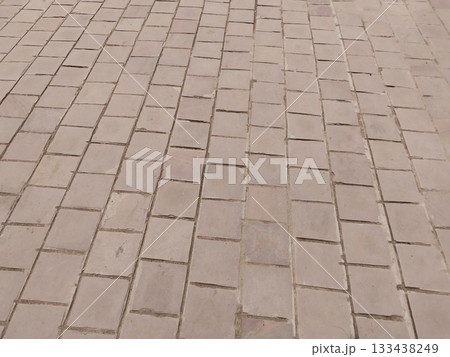 Empty paved courtyard with stone tiles, outdoor ground surface of public urban space, pattern of rectangular paving blocks, blank open area flooring in garden or park, rustic walkway texture Empty paved courtyard with stone tiles, outdoor ground surface of public urban space, pattern of rectangular paving blocks, blank open area flooring in garden or park, rustic walkway texture 133438249