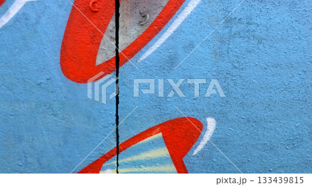 Colorful background of graffiti painting artwork with bright aerosol outlines on wall. Old school street art piece made with aerosol spray paint cans. Contemporary youth culture backdrop 133439815