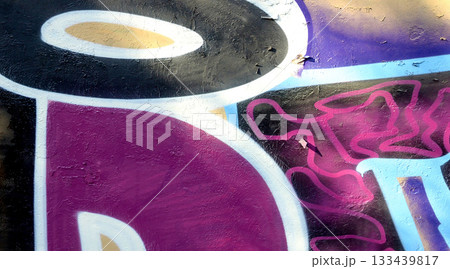 Colorful background of graffiti painting artwork with bright aerosol outlines on wall. Old school street art piece made with aerosol spray paint cans. Contemporary youth culture backdrop 133439817