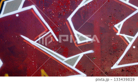 Colorful background of graffiti painting artwork with bright aerosol outlines on wall. Old school street art piece made with aerosol spray paint cans. Contemporary youth culture backdrop 133439819