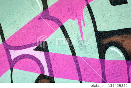 Colorful background of graffiti painting artwork with bright aerosol outlines on wall. Old school street art piece made with aerosol spray paint cans. Contemporary youth culture backdrop 133439822