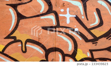 Colorful background of graffiti painting artwork with bright aerosol outlines on wall. Old school street art piece made with aerosol spray paint cans. Contemporary youth culture backdrop 133439823