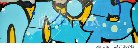 Colorful background of graffiti painting artwork with bright aerosol outlines on wall. Old school street art piece made with aerosol spray paint cans. Contemporary youth culture backdrop 133439843