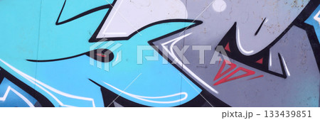 Colorful background of graffiti painting artwork with bright aerosol outlines on wall. Old school street art piece made with aerosol spray paint cans. Contemporary youth culture backdrop 133439851