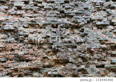 Very old brick stone wall of castle or fortress of 18th century. Full frame wall with obsolete dirty and cracked bricks close up 133440360