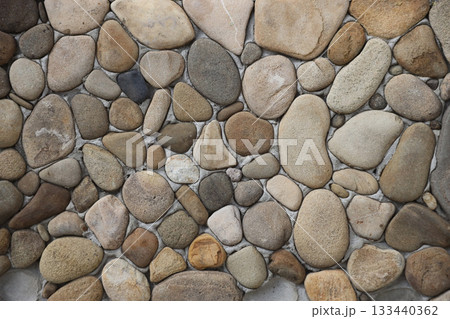 Yellow and brown round shaped pebble stone wall texture close up Yellow and brown round shaped pebble stone wall texture close up 133440362