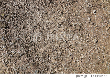 Background of shattered stony stones surface in mountain area. Flat texture with natural light Background of shattered stony stones surface in mountain area. Flat texture with natural light 133440432
