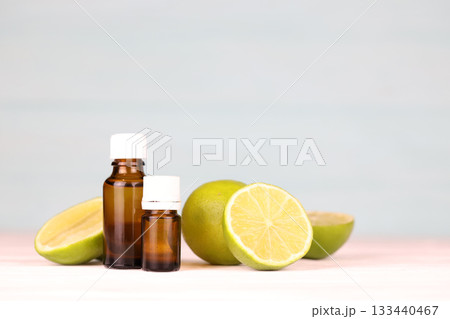 Oil essence bottle with citrus extracts. Selective focus. Spa day, concept of freshness oil bottle with lime extract 133440467