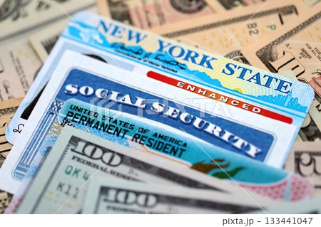 American US dollars money bills with permanent resident, social security ands driving license close up American US dollars money bills with permanent resident, social security ands driving license close up 133441047
