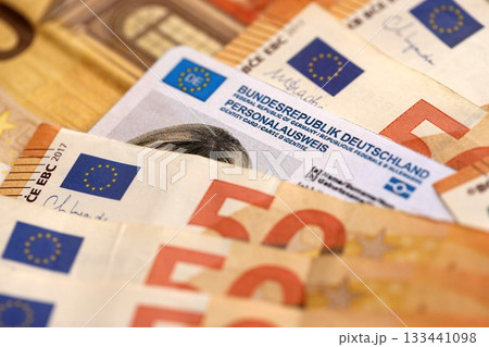 Official German Personalausweis Identity Card as a Symbol of Citizenship among euro money bills close up 133441098