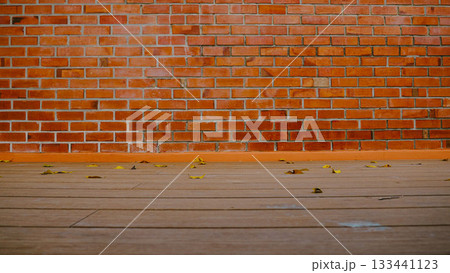 Brick Wall with Wooden Floor and Fallen Leaves Autumn Background Brick Wall with Wooden Floor and Fallen Leaves Autumn Background 133441123