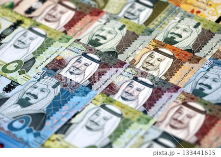 Saudi Arabia riyal money bills banknotes lies in big pile on table close up. Concept of finances and business in Saudi Arabia 133441615