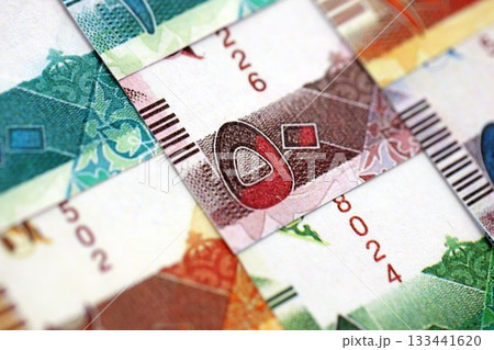 Qatari riyal money bills banknotes lies in big pile on table close up. Concept of finances and business in Qatar 133441620