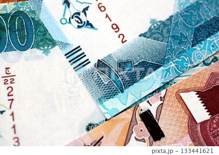 Qatari riyal money bills banknotes lies in big pile on table close up. Concept of finances and business in Qatar 133441621