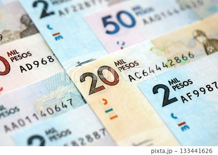 Colombian pesos money bills banknotes lies in big pile on table close up. Concept of finances and business in Colombia Colombian pesos money bills banknotes lies in big pile on table close up. Concept of finances and business in Colombia 133441626