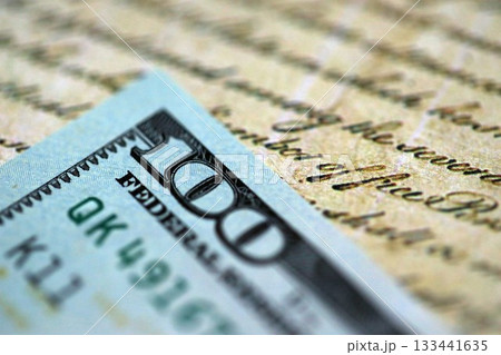One hundred US dollar bills and United States Constitution page fragment. Concept of lawsuit and bribery in United States 133441635