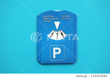 Parking disc for windshield. Limited time parking system in european countries. Concept of parking time count in busy parking lots Parking disc for windshield. Limited time parking system in european countries. Concept of parking time count in busy parking lots 133441699