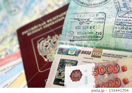 Fragment of Russian Federation visa in passport page and russian money close up. Concept of travel and tourism in Russia 133441704