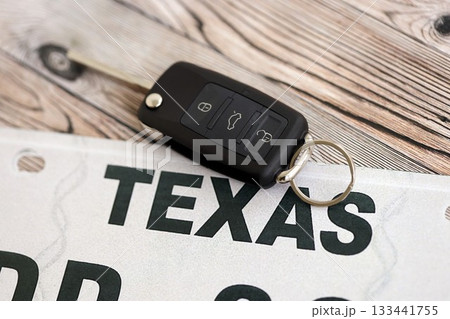 Remote control car keys on Texas license plate on wooden background. Concept of driving in Texas. Reaching a driving permit 133441755