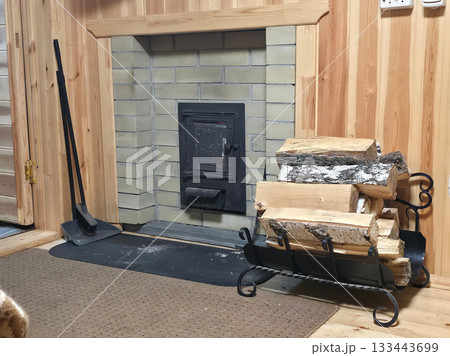 Warm sauna Lounge with Brick Stove and Firewood Rack 133443699