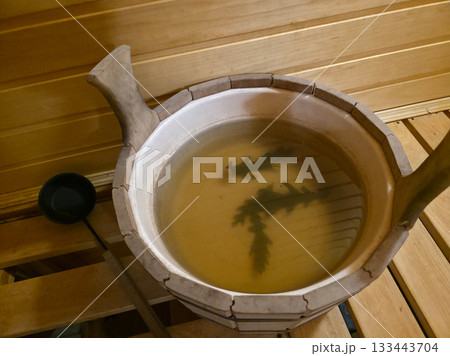 Sauna Bucket with Oak Leaves for Traditional Steam Ritual 133443704