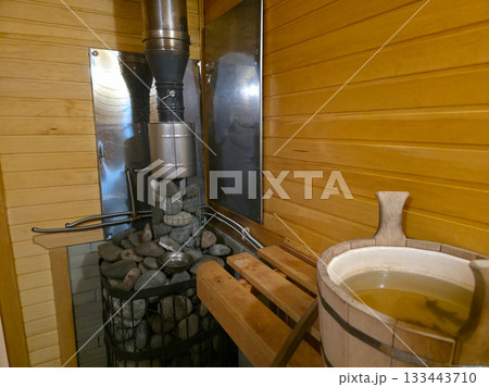 Authentic Russian Banya Interior with Heater and Oak Leaves Authentic Russian Banya Interior with Heater and Oak Leaves 133443710