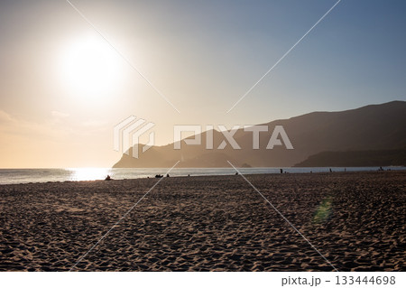 Golden Hour Reflection on Serene Coastal Beach 133444698