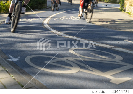 Close Up of a Bicycle Road. Blue Bike Lane With the Bicycles passing on the white symbol of a bike in Konstanz, Germany. 133444721