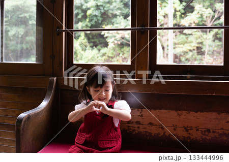 ハートマークを手で作る女の子 133444996