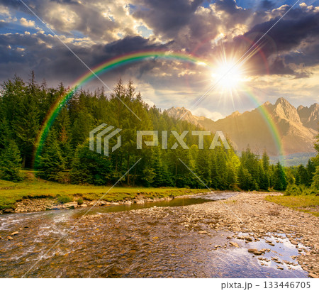 landscape with mountains, forest and a river in front at sunset. beautiful scenery in summer in evening light. water flowing through ecology and sustainability storytelling image under the rainbow 133446705