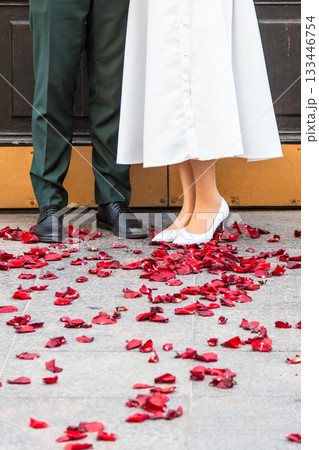 groom and bride on red rose petals outdoors groom and bride on red rose petals outdoors 133446754