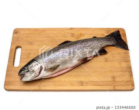 A fish is on a wooden cutting board 133446888