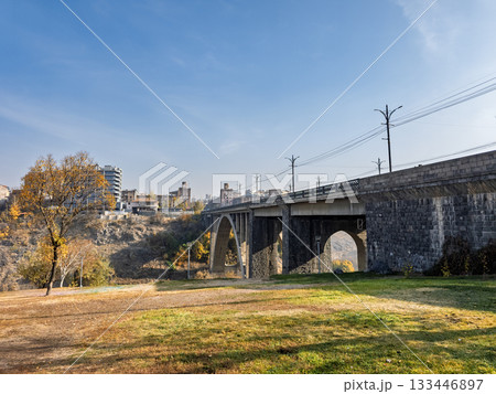 A bridge spans a river in a city 133446897