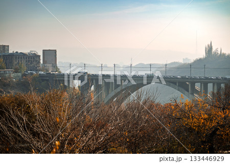 A bridge over a river with a city in the background A bridge over a river with a city in the background 133446929
