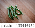 木目のテーブルに置かれたさやいんげん 133446954