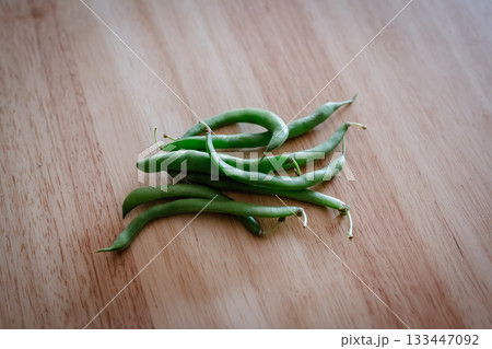 木目のテーブルに置かれたさやいんげん 133447092