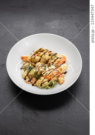 Warm cauliflower salad with broccoli and carrots, dill and balsamic drizzle in white bowl 133447347