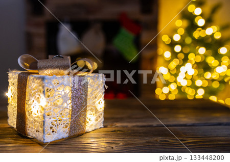 Cozy Christmas Interior with Fireplace, Gift Boxes, and Decorated Tree with Warm Lights 133448200