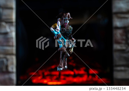Krampus Ornament Carrying Child Hanging on Advent Garland Above Fireplace Krampus Ornament Carrying Child Hanging on Advent Garland Above Fireplace 133448234