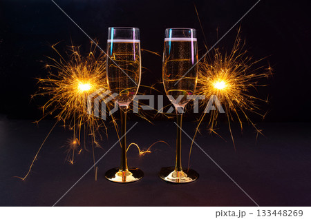Happy New Year 2026, New Year's Eve holiday greeting card celebration. Sparklers firework, champagne glasses on black background Happy New Year 2026, New Year's Eve holiday greeting card celebration. Sparklers firework, champagne glasses on black background 133448269