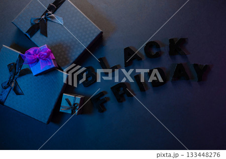 Festive background composition of elegant black gift boxes with black satin ribbons and bows, symbolizing the Black Friday sale. 133448276