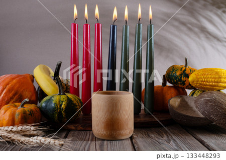 Kwanzaa, african holiday Kwanzaa with decoration of seven candles in red, black and green colors, vegetable harvest, corn. Greeting card banner. Happy Kwanzaa 133448293