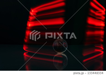 Abstract colorful irregular lines with glass bubble on black background and wall texture. Long exposure. Light painting photography. Abstract colorful irregular lines with glass bubble on black background and wall texture. Long exposure. Light painting photography. 133448334